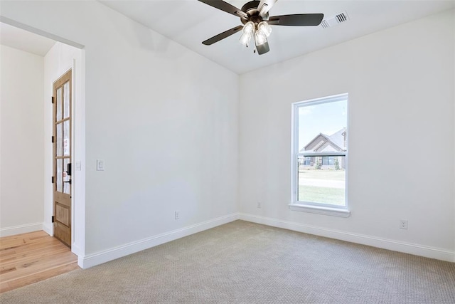 unfurnished room featuring light carpet and ceiling fan