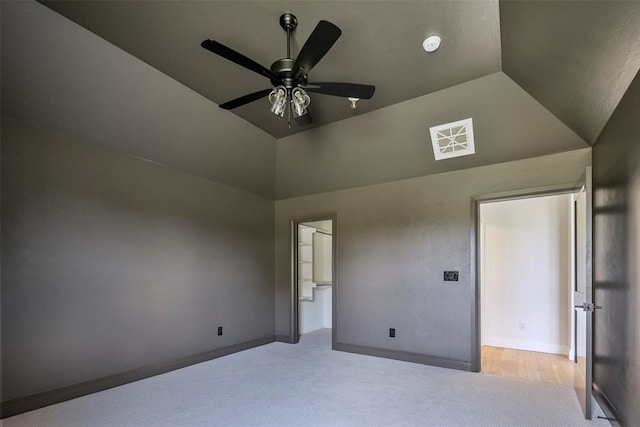 unfurnished bedroom with ceiling fan, light colored carpet, and lofted ceiling