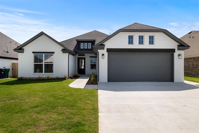 view of front of home with a front yard and a garage