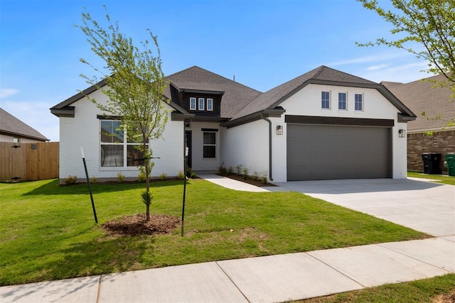 view of front facade featuring a front yard and a garage