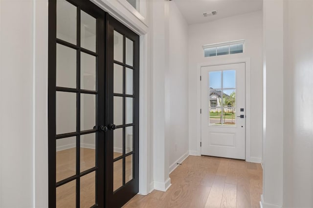 entryway featuring french doors and light wood-type flooring