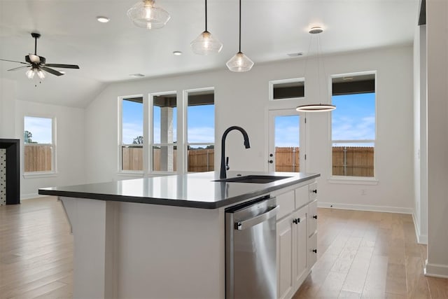 kitchen featuring light wood-type flooring, a kitchen island with sink, sink, dishwasher, and white cabinetry