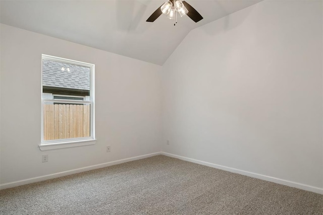 spare room with ceiling fan, lofted ceiling, and carpet floors