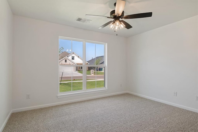 spare room featuring carpet flooring and ceiling fan