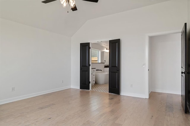 unfurnished bedroom with light hardwood / wood-style floors, vaulted ceiling, ceiling fan, and ensuite bathroom