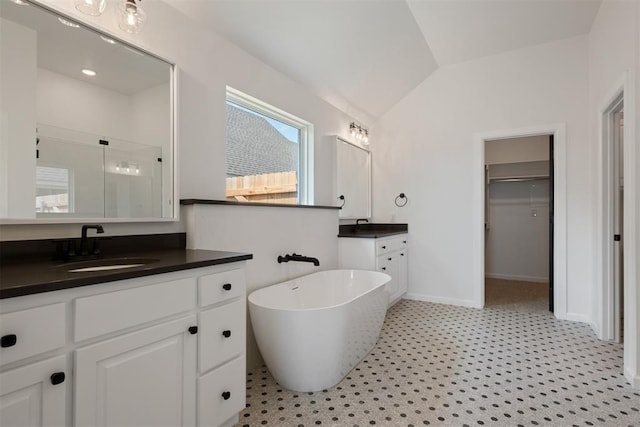 bathroom featuring vanity, vaulted ceiling, and separate shower and tub