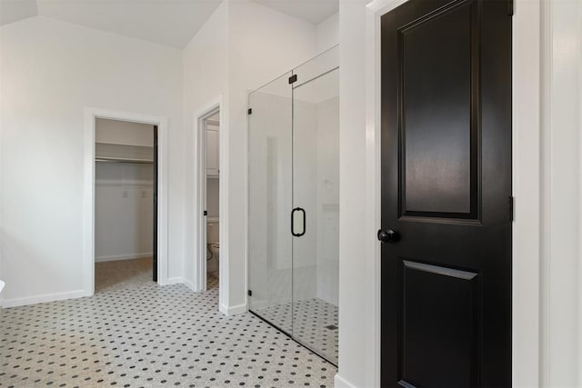 bathroom with an enclosed shower and toilet