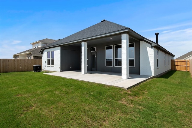 back of property featuring a yard, a patio, and central AC