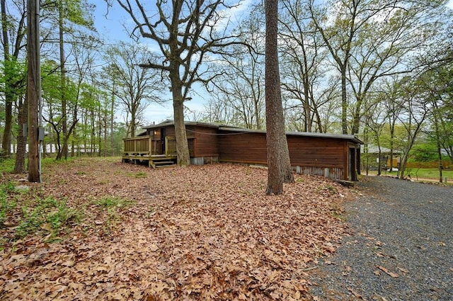 view of side of home with a wooden deck