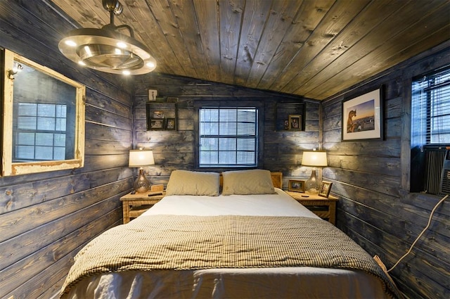 bedroom with lofted ceiling, wooden walls, and wooden ceiling