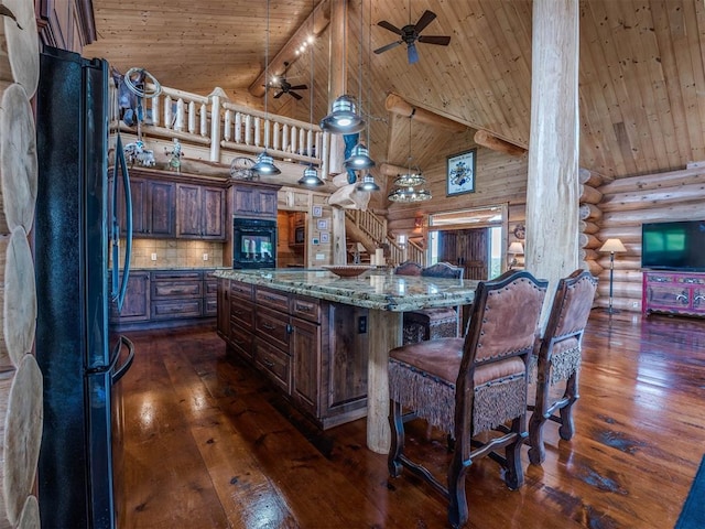 kitchen featuring light stone countertops, black appliances, log walls, wood ceiling, and high vaulted ceiling