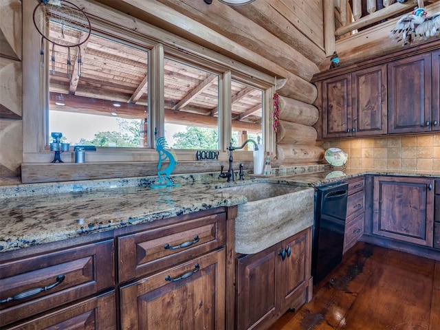 kitchen featuring light stone countertops, dishwasher, sink, dark hardwood / wood-style floors, and rustic walls