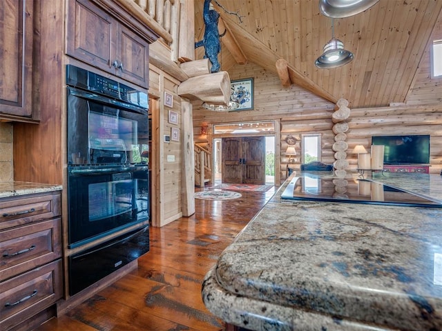 kitchen featuring dark hardwood / wood-style flooring, log walls, black double oven, light stone counters, and wooden ceiling