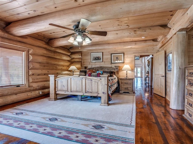 bedroom featuring ceiling fan, dark hardwood / wood-style floors, rustic walls, and multiple windows