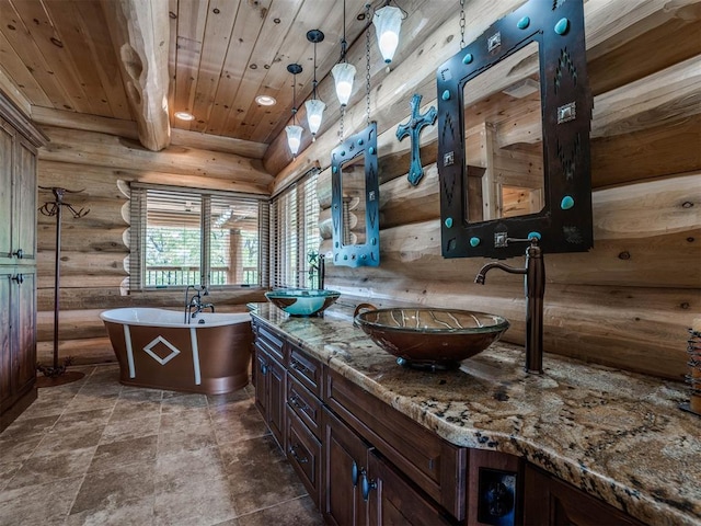 bathroom with log walls, vanity, a bath, wooden ceiling, and beam ceiling