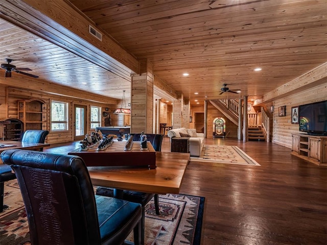 living room featuring ceiling fan, dark hardwood / wood-style floors, wood walls, wood ceiling, and log walls