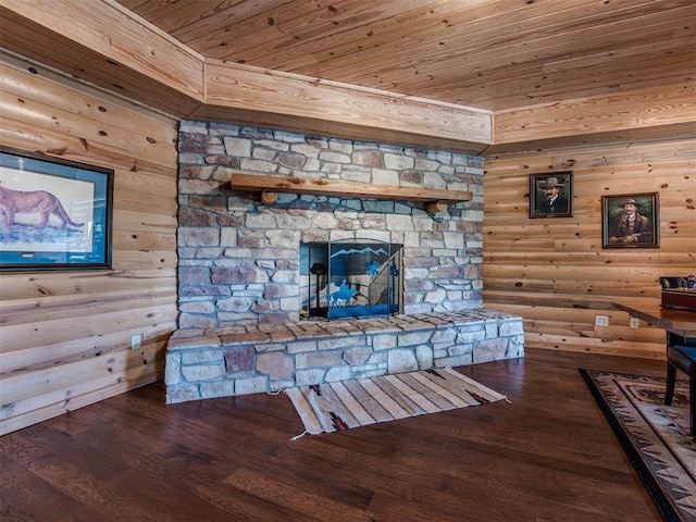 living room featuring wood ceiling, log walls, wood-type flooring, and a stone fireplace