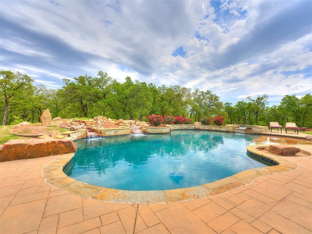 view of pool with pool water feature and a patio