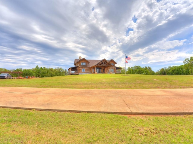 cabin with a front lawn