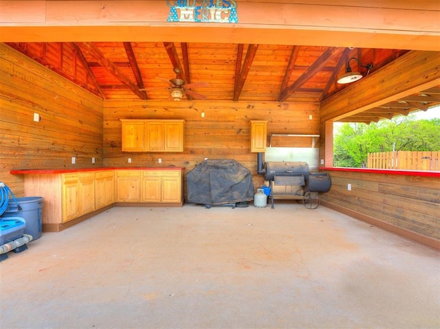 exterior space featuring lofted ceiling with beams, wood ceiling, and wooden walls