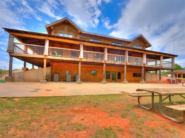 rear view of house with a patio area, a deck, and central AC unit