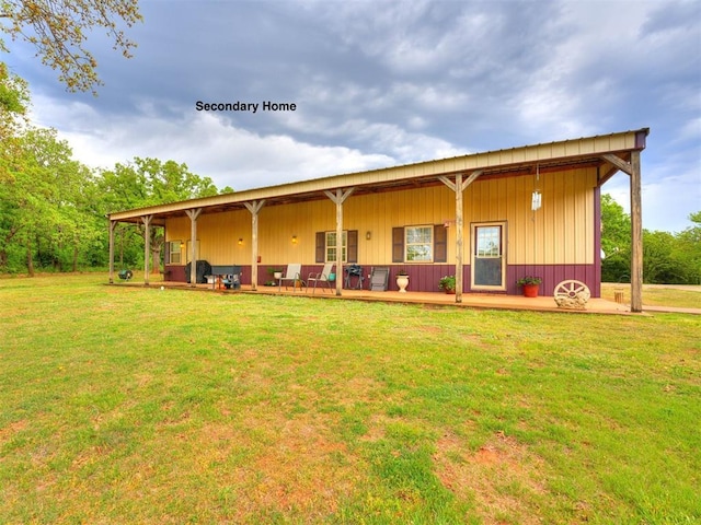 rear view of property featuring a yard