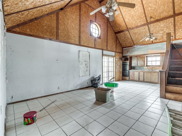 interior space featuring ceiling fan, sink, a healthy amount of sunlight, and lofted ceiling