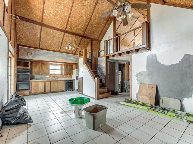 kitchen with ceiling fan, sink, wine cooler, high vaulted ceiling, and double oven