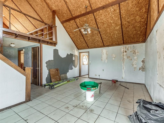 tiled spare room featuring vaulted ceiling and ceiling fan