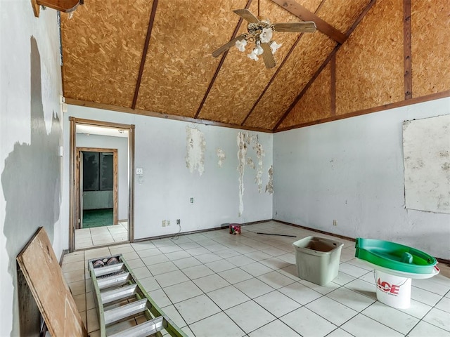 tiled empty room featuring ceiling fan and lofted ceiling