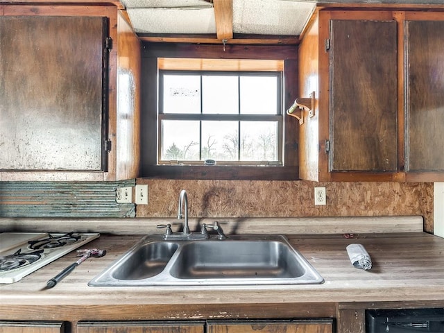 kitchen featuring white gas cooktop, sink, and tasteful backsplash