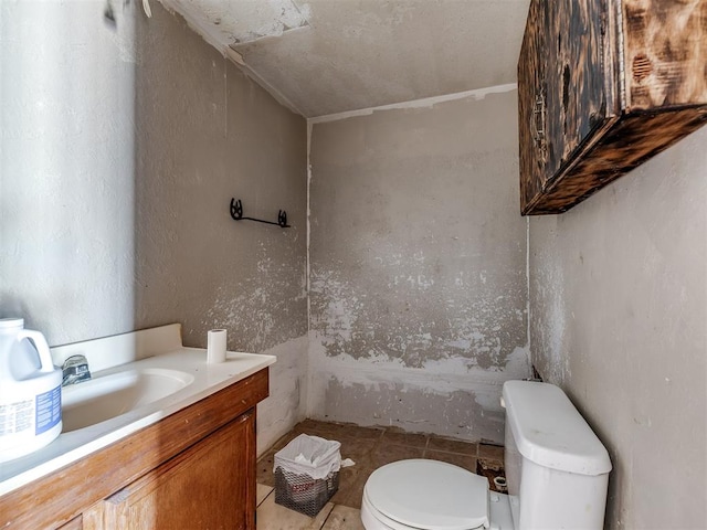 bathroom featuring tile patterned flooring, vanity, and toilet