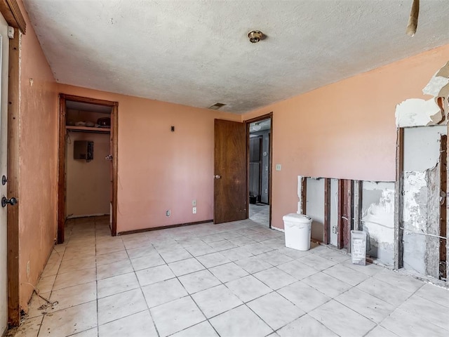 unfurnished room featuring a textured ceiling