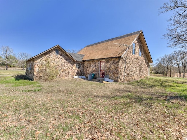 view of home's exterior with a lawn