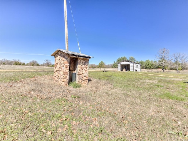 view of yard with a rural view and a shed