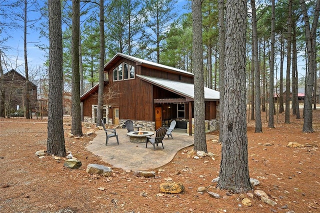 view of home's exterior featuring a fire pit