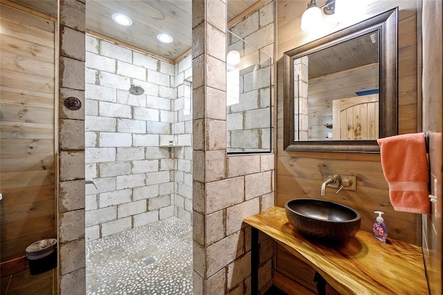 44 Blue Ivey Cir, Broken Bow, OK 74728 - bathroom with tiled shower, vanity, wood walls, and recessed lighting