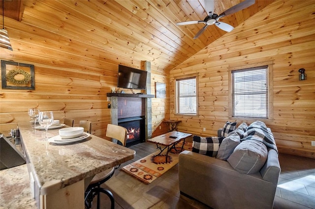44 Blue Ivey Cir, Broken Bow, OK 74728 - living room with wooden ceiling, lofted ceiling, ceiling fan, a lit fireplace, and wood walls
