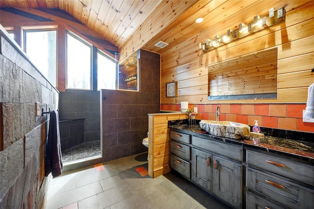 bathroom with walk in shower, tile patterned floors, vaulted ceiling, wood ceiling, and tile walls