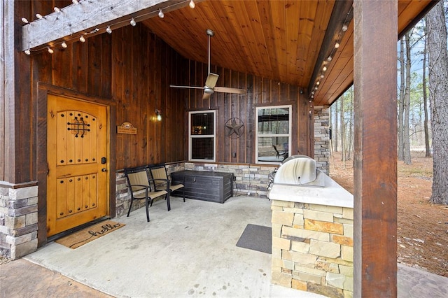 44 Blue Ivey Cir, Broken Bow, OK 74728 - entrance to property featuring stone siding, a patio, a ceiling fan, and board and batten siding