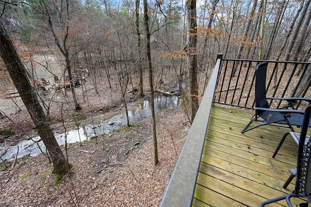 wooden terrace featuring a water view