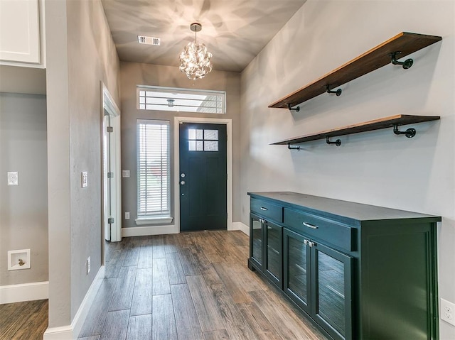 foyer entrance with hardwood / wood-style flooring and a chandelier