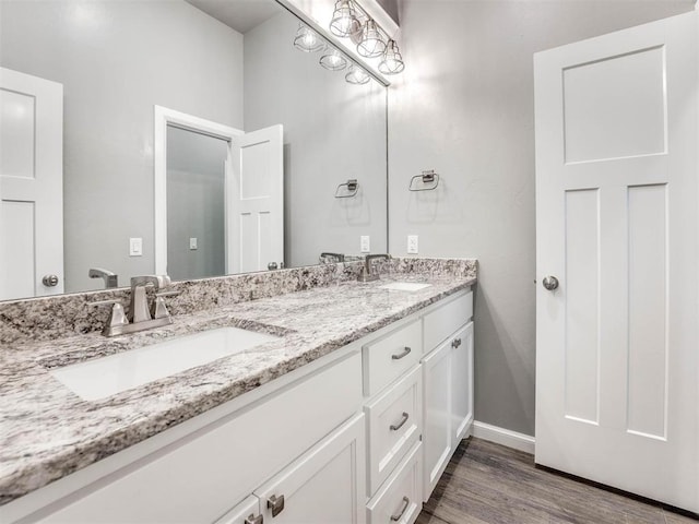 bathroom with hardwood / wood-style floors and vanity