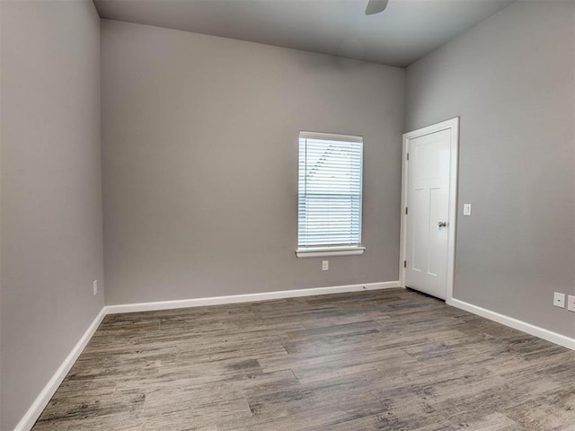 unfurnished room with hardwood / wood-style floors and ceiling fan