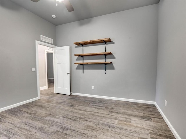 spare room featuring ceiling fan and light hardwood / wood-style floors