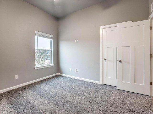 unfurnished bedroom featuring carpet and ceiling fan