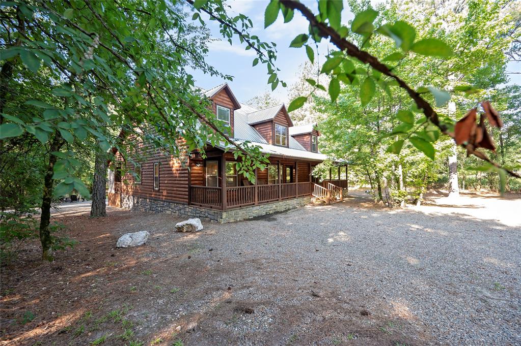 view of side of property featuring covered porch