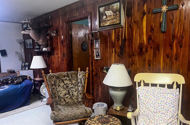 sitting room featuring wood walls