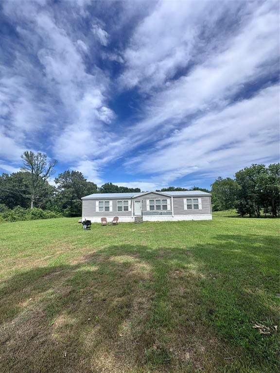 back of property featuring a yard