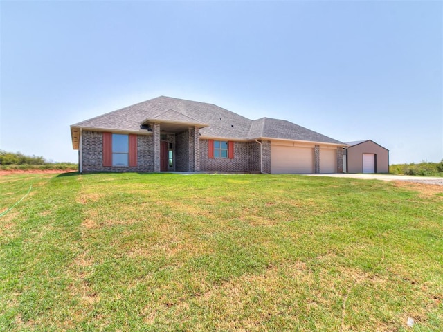 view of front of home with a front lawn and a garage